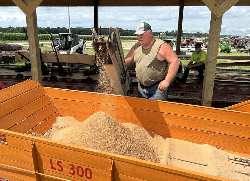 Jim Gempeler of Wisconsin watches as sawdust is pumped from a sawmill powered by a steam engine at the Bos Brothers Historical Farm south of Erie on Friday, July 25, 2025.
