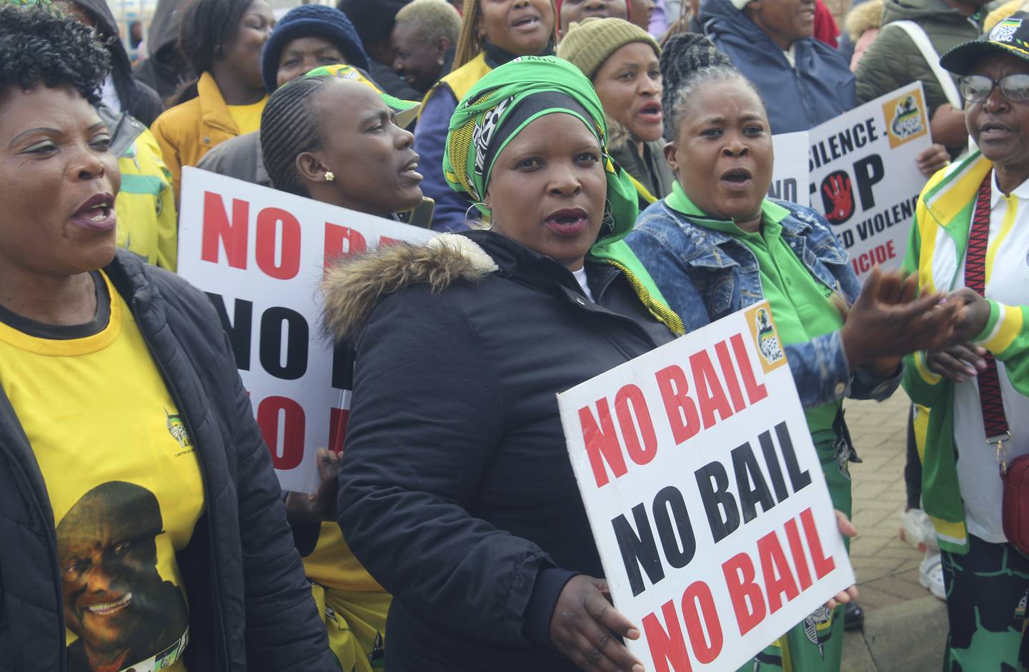 Protestors demonstrate outside the court in Polokwane South Africa, where three men accused of killing two women and feeding their bodies to pigs appear in court.