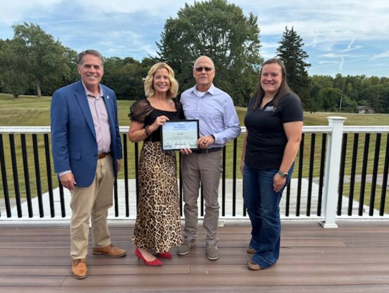 Don Lamb (from left), Kelli Guernsey, Bruce Guernsey and Lindsey Bluhm pose for a photo after presenting and receiving the inaugural Weaver Popcorn Manufacturing Stewardship Award.