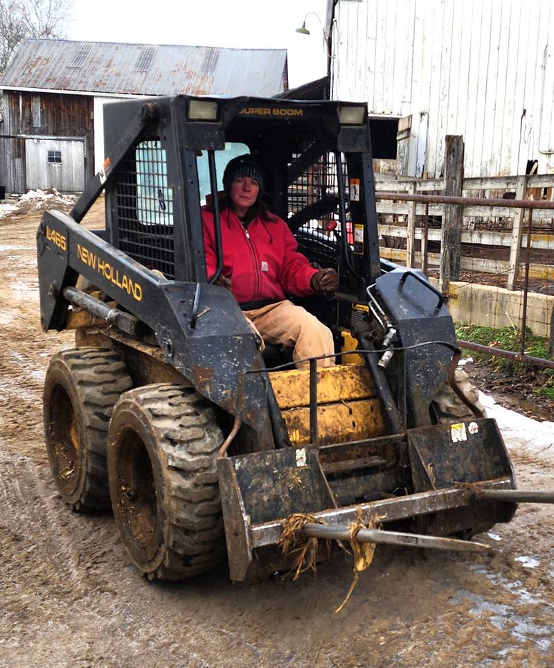 Farmer Mindy Orschell drives a Bobcat on her farm in southern Indiana.