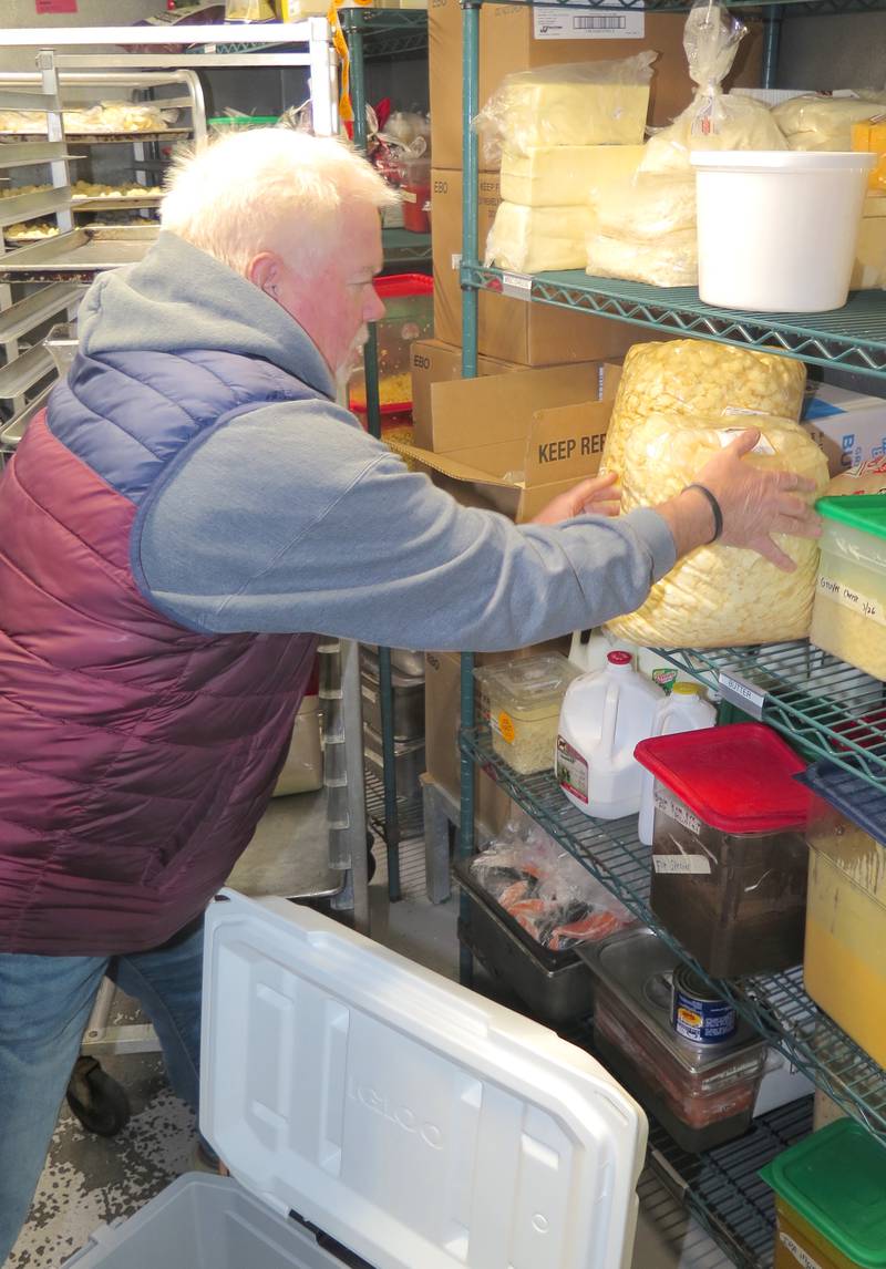 Ken Ropp places a second bag of cheese curds on the cooler shelf at Destihl Beer Hall and Barrel Room in Normal, Illinois. The two Destihl locations combined use about 800 pounds of Ropp Jersey Cheese curds each month.