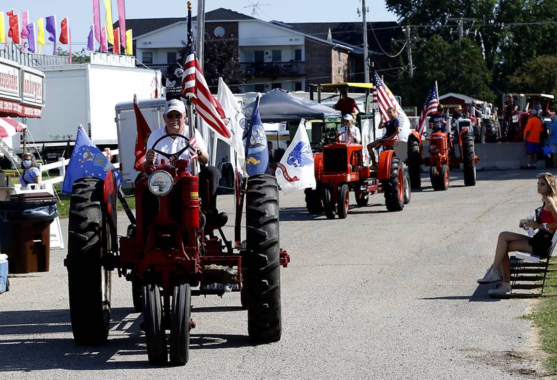 Harry Alten leads the antique tractor parade in his 1939 Farmall Model F-14 tractor during the first day of the McHenry County Fair Tuesday, August 2, 2022, at the fairgrounds in Woodstock. The fair funs through Sunday, Aug. 7.  Entry to the fair is $10 for anyone over age 14, and $5 for chidden ages 6 to 13. Ages 5 and under are free.