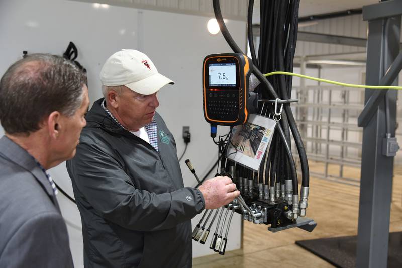 Veterinarian Rob Jackman (right) gives Don Lamb, the director of the Indiana State Department of Agriculture, a tour of the  Jackman Animal Clinic’s large animal haul-in facility.