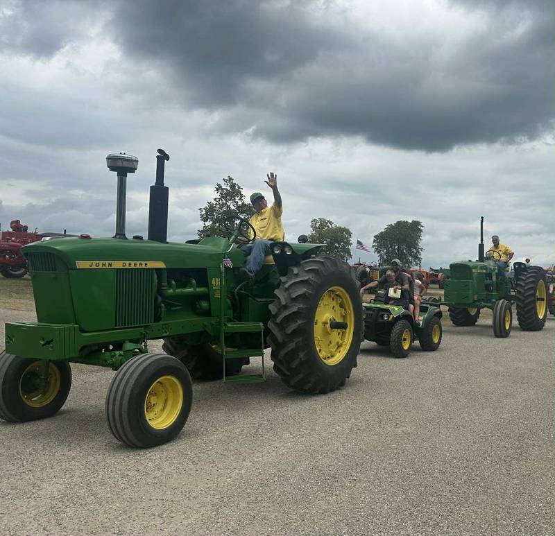 Ed Winkleman drives his John Deere 4020 tractor. At one time he owned three 4020 tractors, but now he is down to one along with seven other John Deere tractors in his collection.