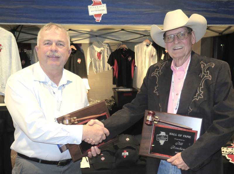 Joe Orwig (left) and Bill Houchens congratulate each other after their induction into the Illinois State Auctioneers Association Hall of Fame induction Feb. 9 during the group’s annual conference.