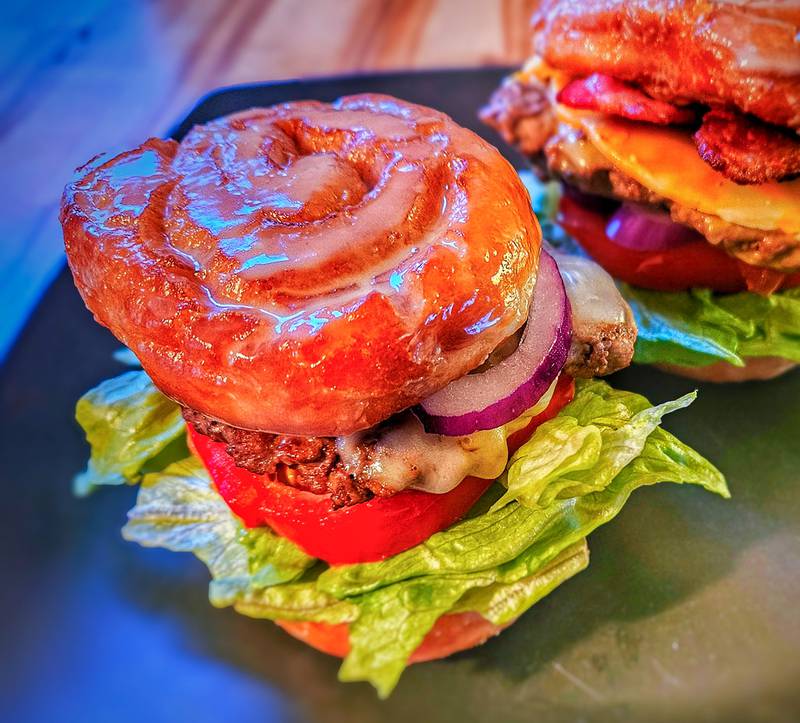 Bacon Honeybun Burger by McWaters Concessions. Fresh angus burger resting between grilled honeybuns, topped with bacon, cheese and your choice of garden toppings.