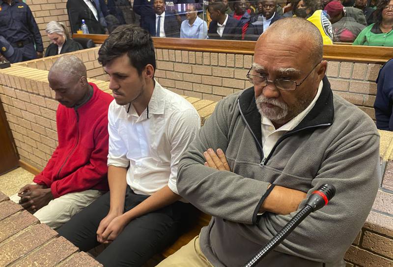 Three men accused of killing two women and feeding their bodies to pigs, farm owner Zachariah Olivier (from right), supervisor Adrian Rudolph de Wet and employee William Musora, appear in court in Polokwane, South Africa.