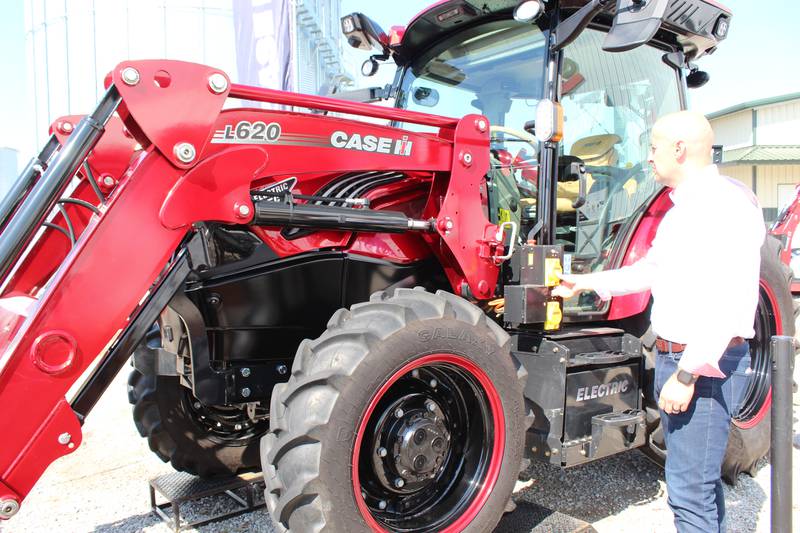 Kurt Coffey points out some of the features of the new Case IH Farmall 75C Electric tractor on the lot at the Farm Progress Show. The electric tractor has a four-plus hour run time which is a reasonable duty cycle for many farmers who are doing chores, loader work or mowing around the farm.