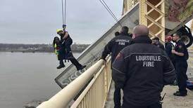 Pickup truck driver charged for role in crash that left tractor-trailer dangling from bridge