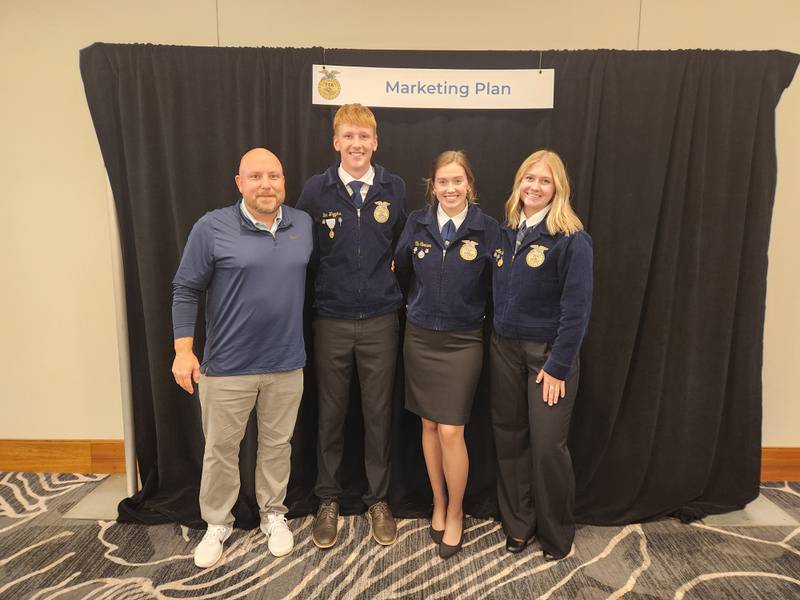 Chris Kaufman (far left) stands with students participating in the Marketing Plan Career Development Event. Kaufman was honored as a Golden Owl Award finalist.