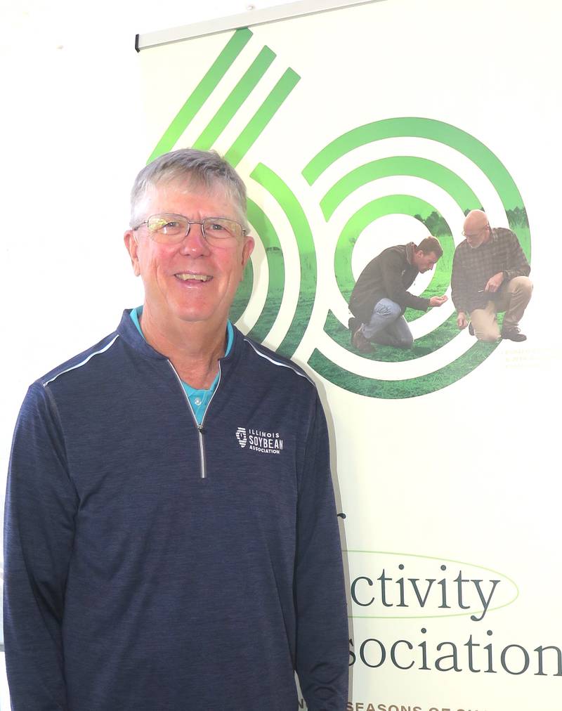 Ron Kindred, Illinois Soybean Association chair, stands next to the organization’s 60th anniversary logo at the Illinois State Fair. The yearlong celebration will culminate with a banquet in November.