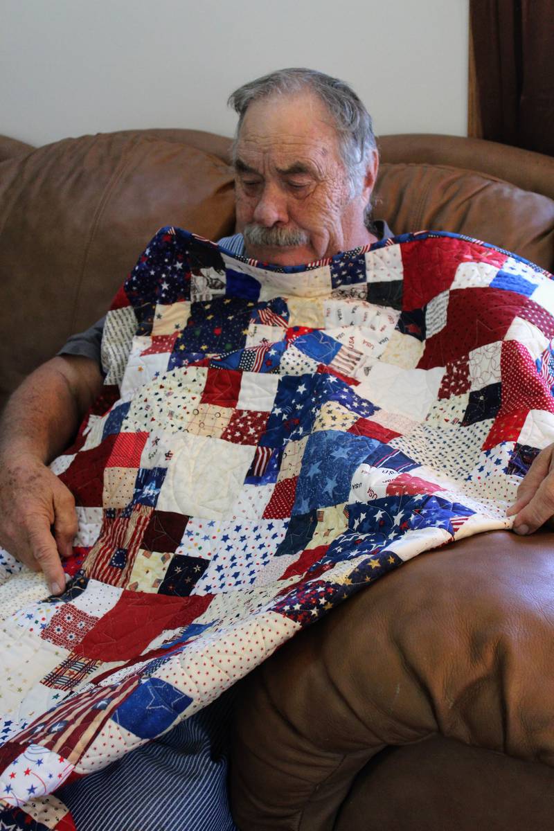 Richard Siedenburg displays his Quilt of Valor that he received earlier this year, handmade especially for him. At 19 years old, Siedenburg enlisted in the Army and served in the Army Reserves for decades.