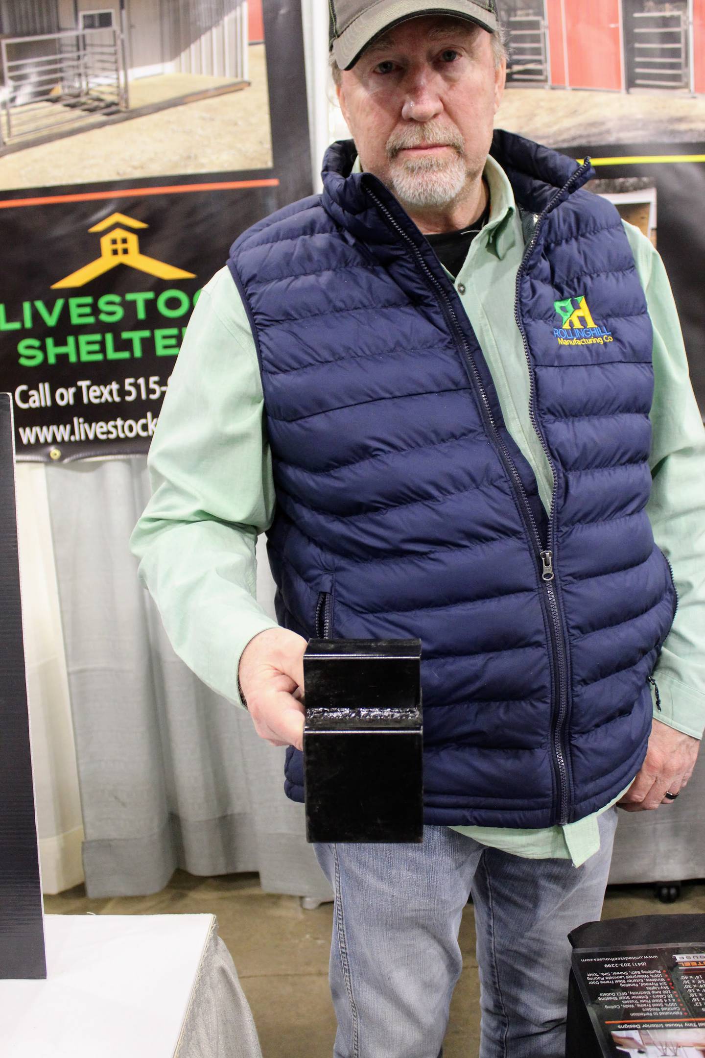 Ken Wright shows the quality of the steel that his company uses to make livestock shelters. This is the second year he has participated in the trade show during the Illinois Beef Expo.