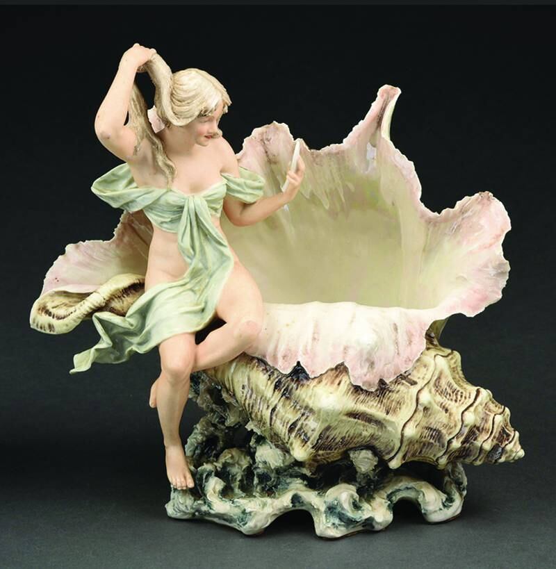 Some collectibles are found in nature; some imitate them. If it weren’t for the attached figure, this Royal Dux porcelain vase might pass for a real conch shell.
