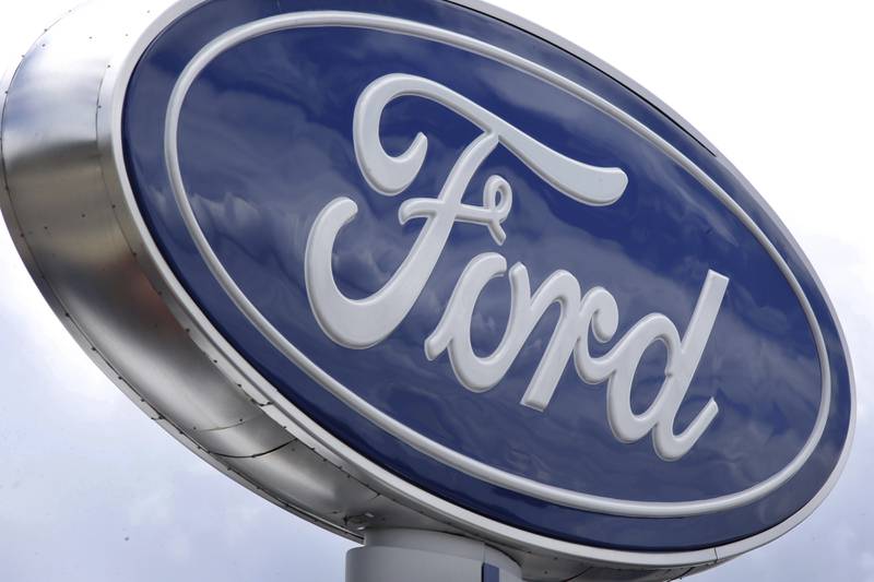 Clouds are reflected in the Ford sign at a dealership in Wexford, Pennsylvania.