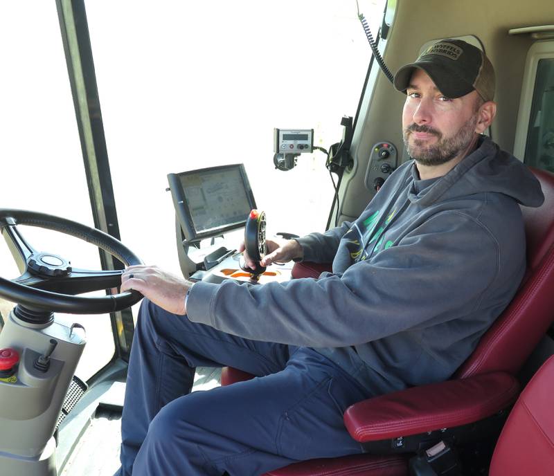Jeremy Rutledge wraps up harvesting a McDonough County cornfield east of Macomb, Illinois, on Oct. 18. Rutledge, a fifth-generation farmer, served for 14 years in the U.S. Army before returning to the family farm.