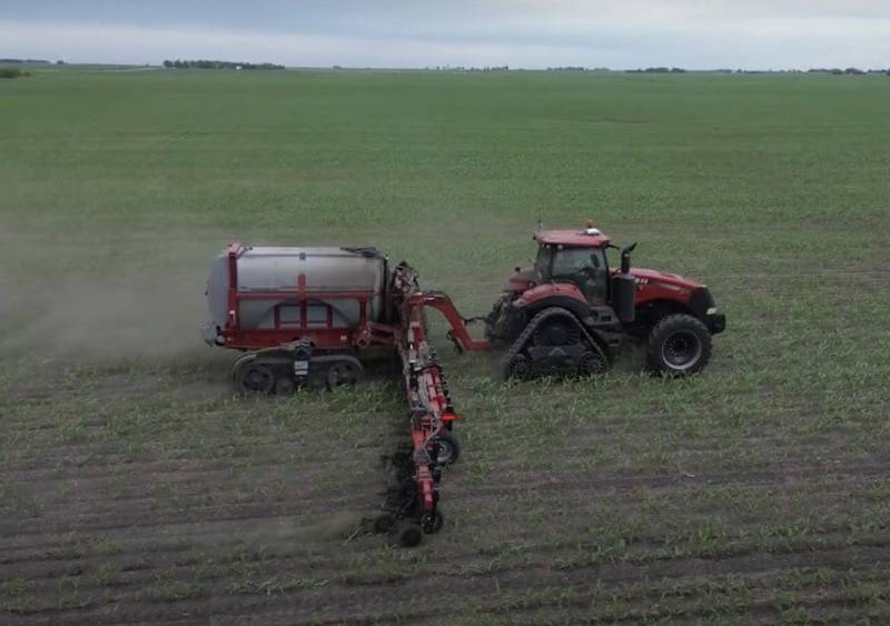 A farmer applies nitrogen fertilizer to a cornfield in Boone County in the central Iowa in June 2024.