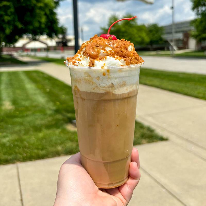 Cookie Butter Cold Brew Float by Hooks Drugstore Museum. It’s a vanilla cold brew with vanilla ice cream. Topped with whipped cream, cookie butter drizzle, cookie crumbles and a cherry.