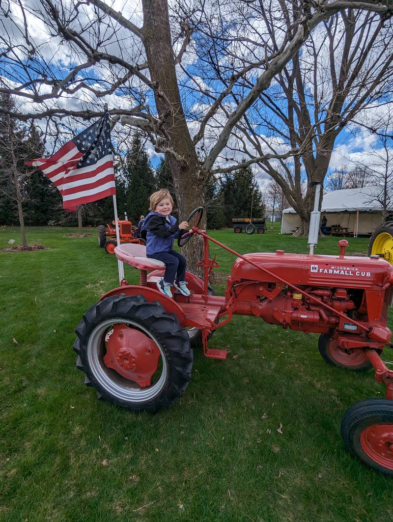 Maxwell Weiler, 3, of St. Charles, sits behind the wheel of a vintage McCormick Farmall Cub Tractor at Touch-A-Tractor at the Kane County Farm Bureau in St. Charles.