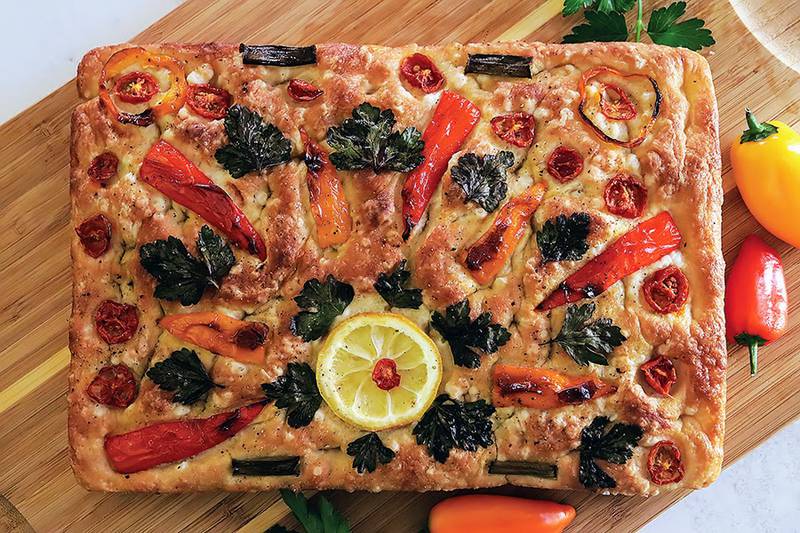 Vibrant bell peppers and fresh herbs decorate this flavorful focaccia.