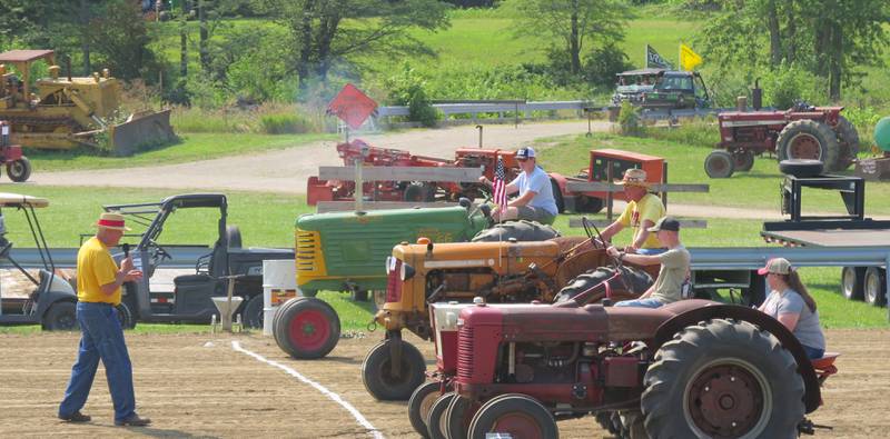 Tractor games entertain spectators at the grandstand during Historic Farm Days. Other activities include the daily tractor parade, corn shelling, blacksmith shop, field demonstrations, sawmilling and other events.