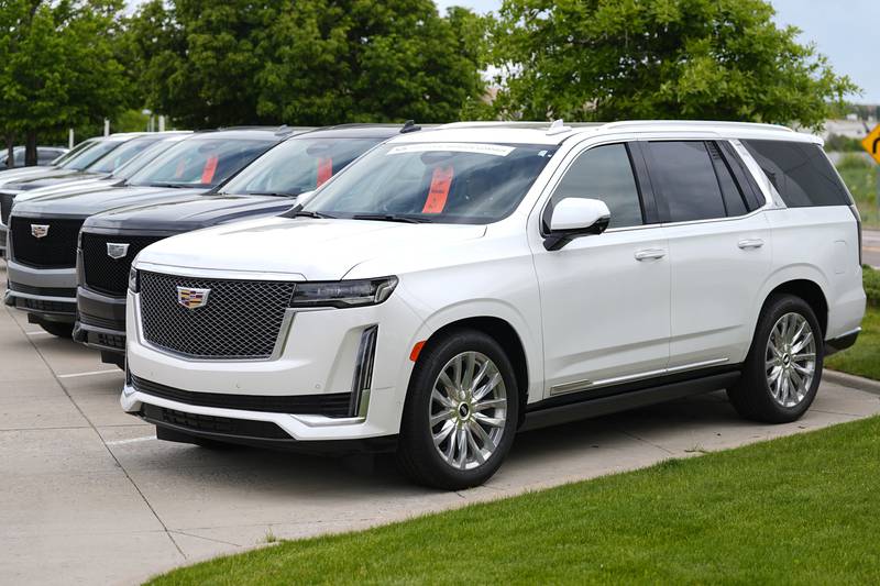 Unsold 2024 Escalade utility vehicles are parked at a Cadillac dealership in Lone Tree, Colorado.