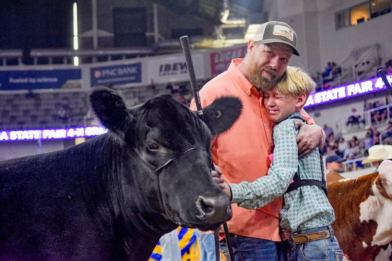 Andy and Coldar Cunningham (from left) celebrate after placing fifth heifer overall at the Indiana State Fair.