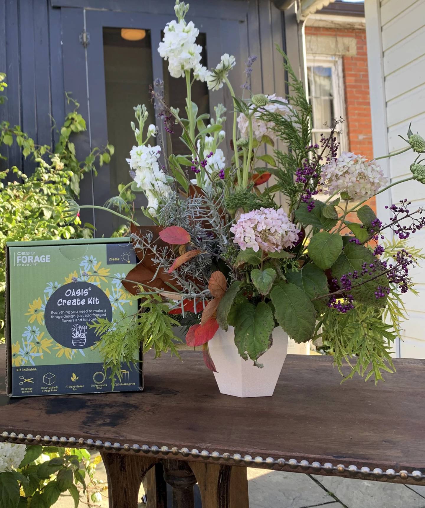 This image provided by OASIS Forage Products shows a floral arrangement, right, created using an OASIS Create Kit.