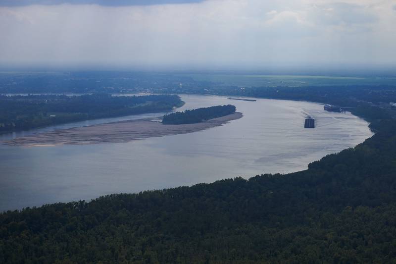 In this aerial photo a tugboat pushing barges navigates around sandbars amid low water levels on the Mississippi River in Livingston Parish, Louisiana.