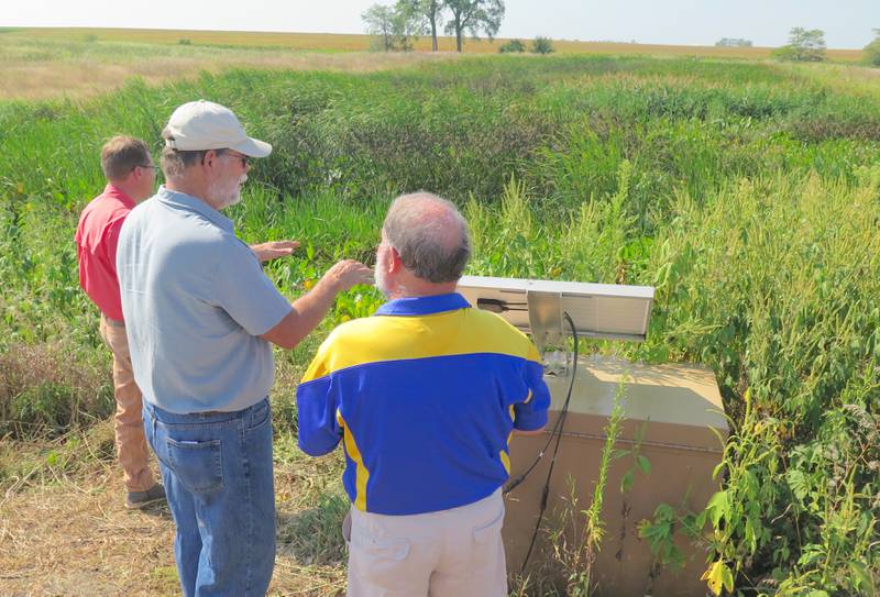 Jim Fulton points out various aspects of his constructed wetland to Gary Bressner, Livingston County Soil and Water Conservation District board member, during a recent field tour. Fulton had the wetland installed to address nutrient loss.