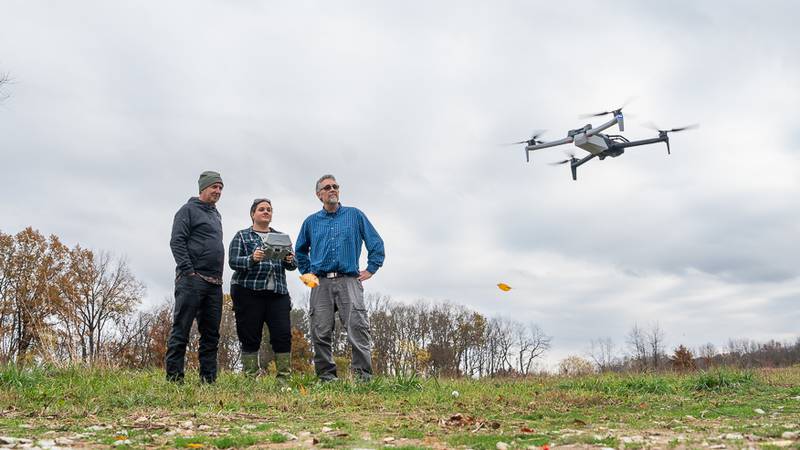 Purdue University’s Joseph Hupy (left), professor of aviation and transportation technology, and Pat Zollner (right), professor of forestry and natural resources, supervise students, including Tina Jackson (center), graduate student in forestry and natural resources, to use drones with thermal cameras to document wildlife populations.