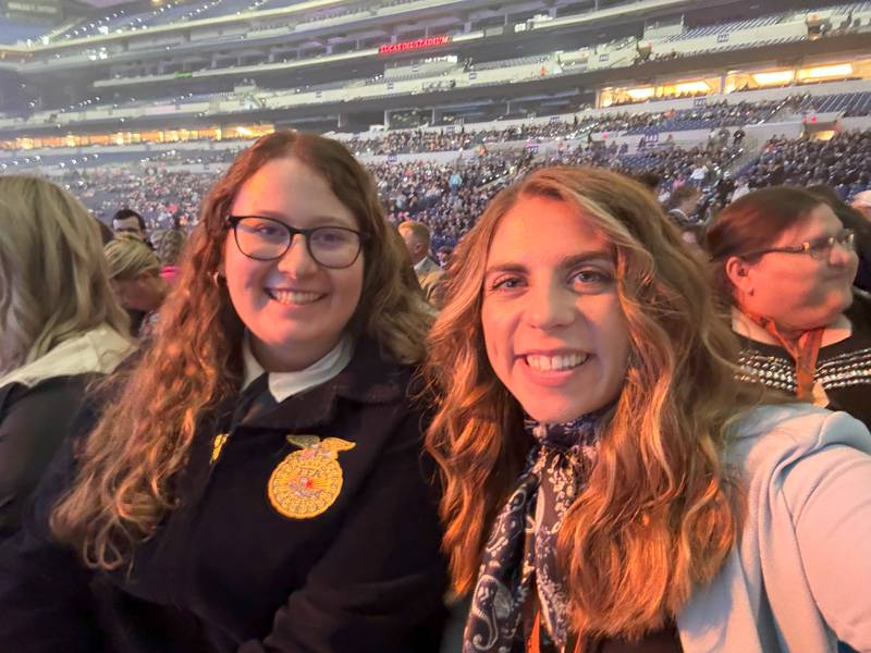 Rebekah Peterson poses for a photo with a student at National FFA Convention. Peterson is a finalist for the Golden Owl Award for her dedication to teaching students about agriculture.
