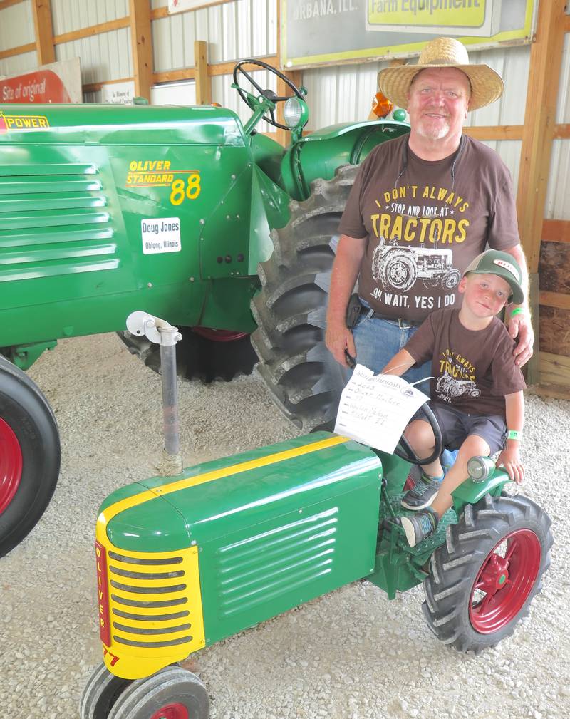 Cliff McNames’ grandson, Waylon McLean, sits on the Oliver 77 at Historic Farm Days that his grandfather built from scratch. McNames, who has a knack for restoring unique “stuff,” hopes to have his rare 1905 wood framed tractor on display at the Half Century of Progress.