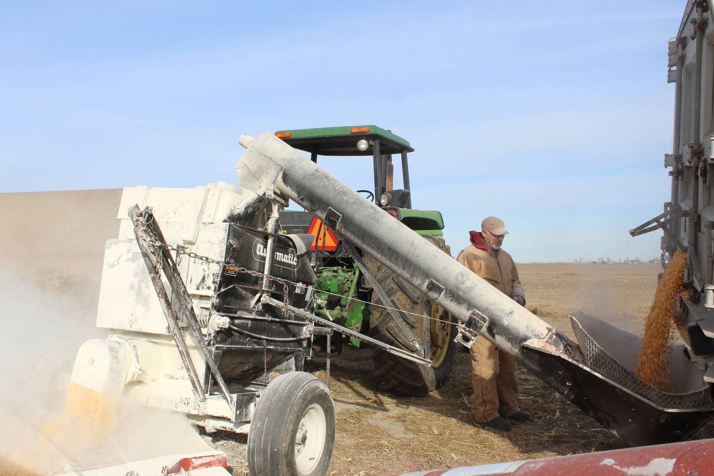 A roller mill is used to crack corn for part of the high-energy ration for the feeder cattle at the Rahn farm. The cattlemen will process enough corn for the next six weeks of ration that also includes wet distillers grain and ground cornstalks and grass.