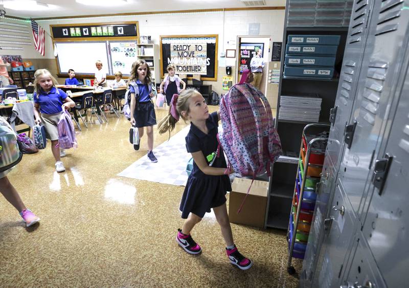 Savannah Knott hangs up her backpack for the day on the first day in her second grade classroom at Mary Carrico Catholic School in Knottsville, Kentucky.