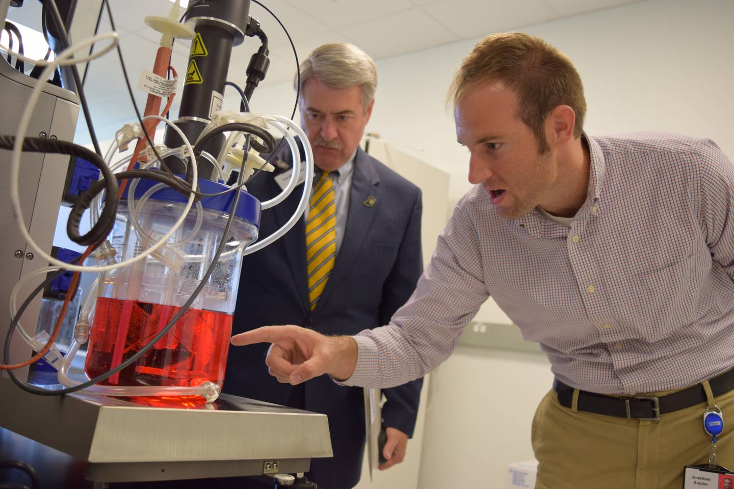 Ted McKinney (left) and Jonathan Snyder, research scientist at Elanco Animal Health, check out a bioreactor that is used to grow cells. The reactor is part of a lab in the Vaccines Innovation Center. Companies like Elanco offer a variety of jobs ranging from laboratory work to corporate communications.