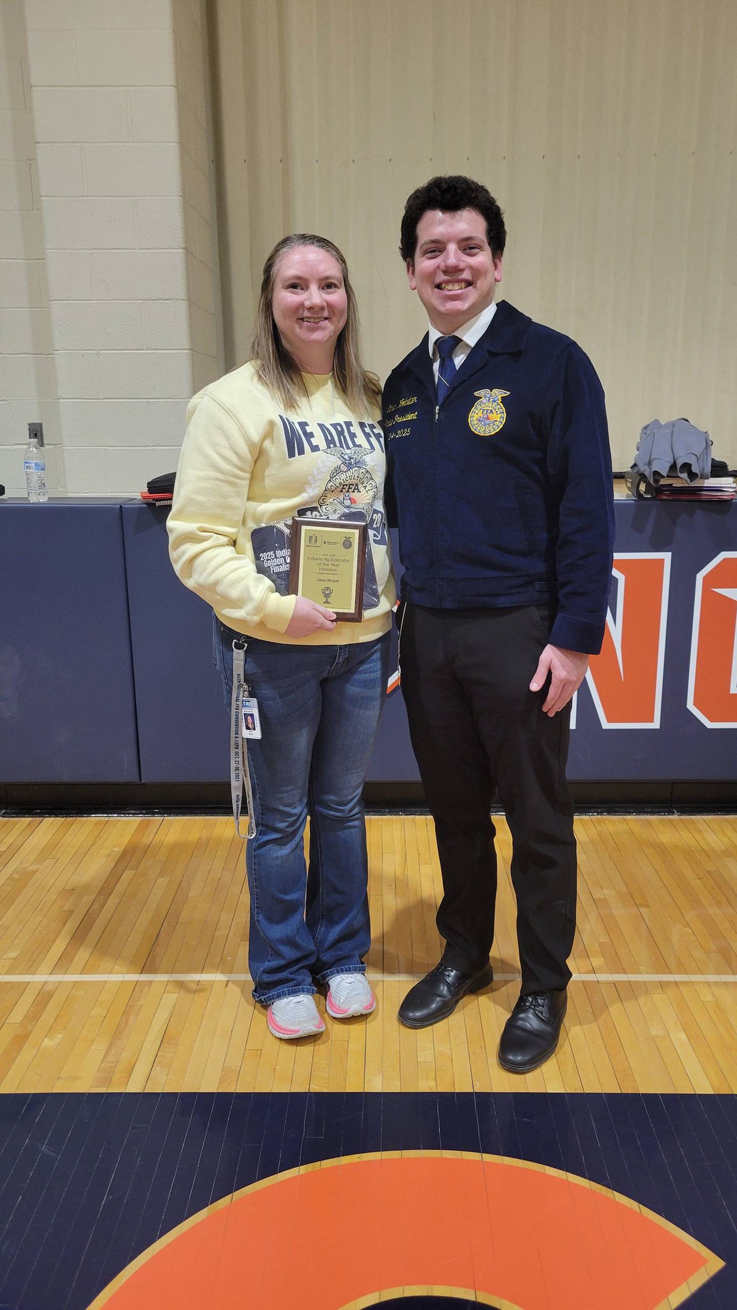 Janna Morgan (left) and Indiana FFA State President Ethan Wolheter celebrate Morgan being honored as a Golden Owl Award finalist for her work as an ag educator.