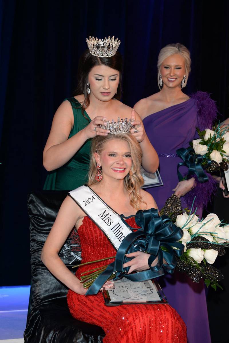 Natalie Evans, Morgan County Fair Queen, is crowned 2024 Miss Illinois County Fair Queen by 2023 Miss Illinois County Fair Queen Paige Van Dyke, as Tessa Sergeant, Hancock County Fair Queen and the first runner-up, watches. Evans, from Jacksonville, is the first state fair queen from Morgan County. She competed along 72 other county fair queens at the annual pageant, sponsored by the Illinois Association of Agricultural Fairs and held during the IAAF’s annual convention in Springfield.