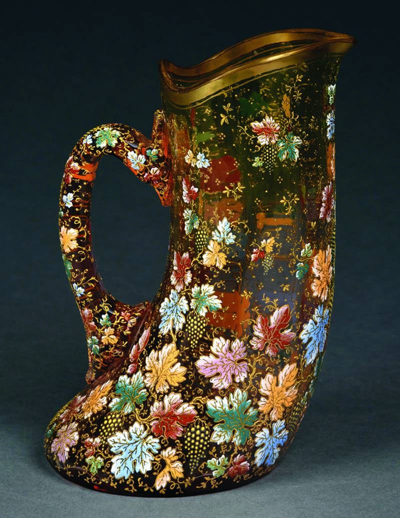 This antique Moser pitcher is decorated with enameled grapevines on shaded red-to-green glass.