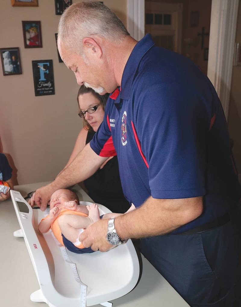 Project Swaddle paramedic Darren Forman makes an at-home visit to check on a baby’s health.