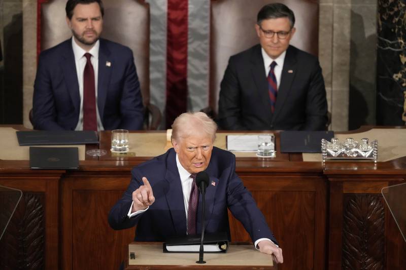 President Donald Trump speaks as Vice President JD Vance (left) and House Speaker Mike Johnson, of Louisiana, listen as Trump addresses a joint session of Congress at the Capitol in Washington on March 4.