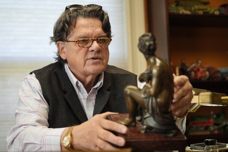 Appraiser Kaja Veilleux inspects a bronze piece for a client at Thomaston Place Auction Galleries in Thomaston, Maine.