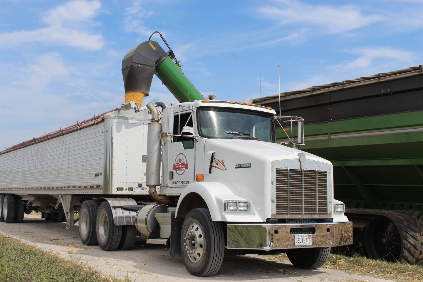 Corn is loaded into a truck before it is taken to be dried at the Rahn grain handling facility. The family starts harvesting corn first to take advantage of the early delivery corn to an ethanol plant.