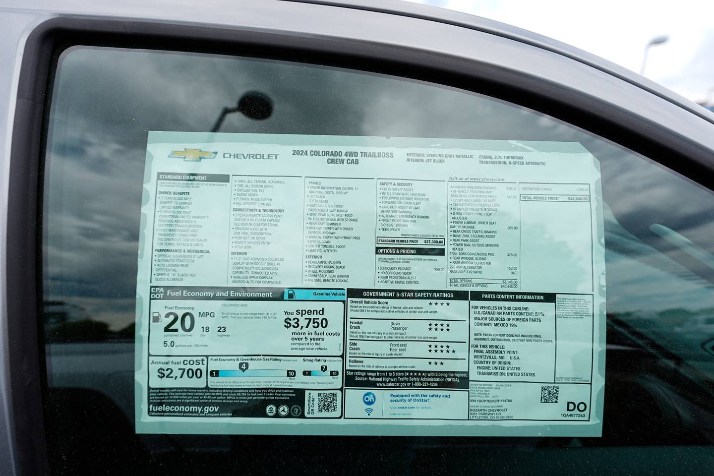 A sticker shows the price for an unsold 2024 Colorado pickup truck at a Chevrolet dealership.