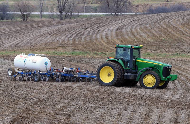 A farmer applies anhydrous ammonia fertilizer to a field. The closure of the Strait of Hormuz is keeping critical fertilizer supplies and crude oil from reaching global markets, putting a squeeze on supplies around the world.