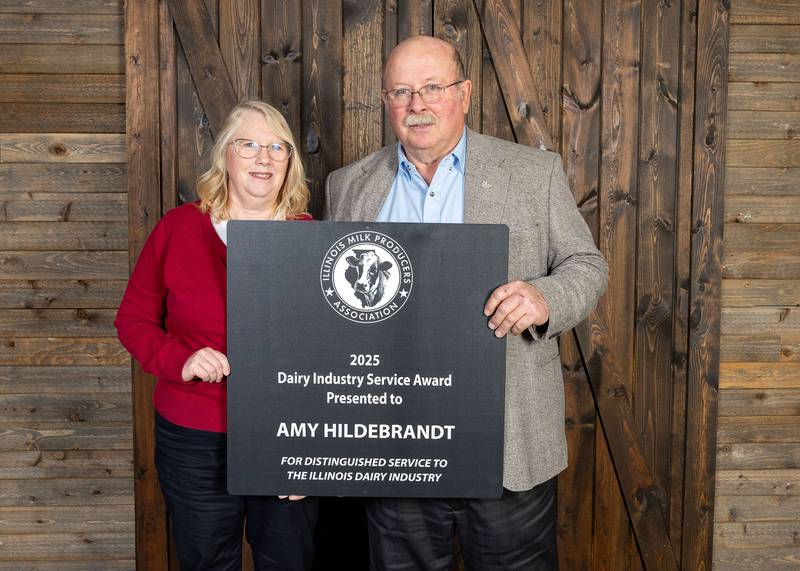 Amy Hildebrandt, winner of the Illinois Milk Producers Association Dairy Industry Service Award, poses with IMPA President Don Mackinson.