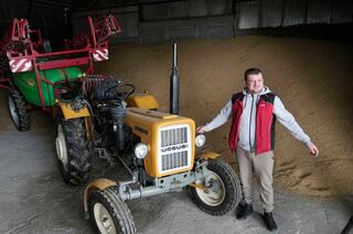 Piotr Korycki, a 34-year-old farmer, stands in a warehouse filled with grain on his farm in Poland. Korycki has been organizing protests of farmers that have been taking place for the past three months in Poland. They are among the Europe-wide protests by farmers angry about imports from Ukraine which they say are driving down prices.