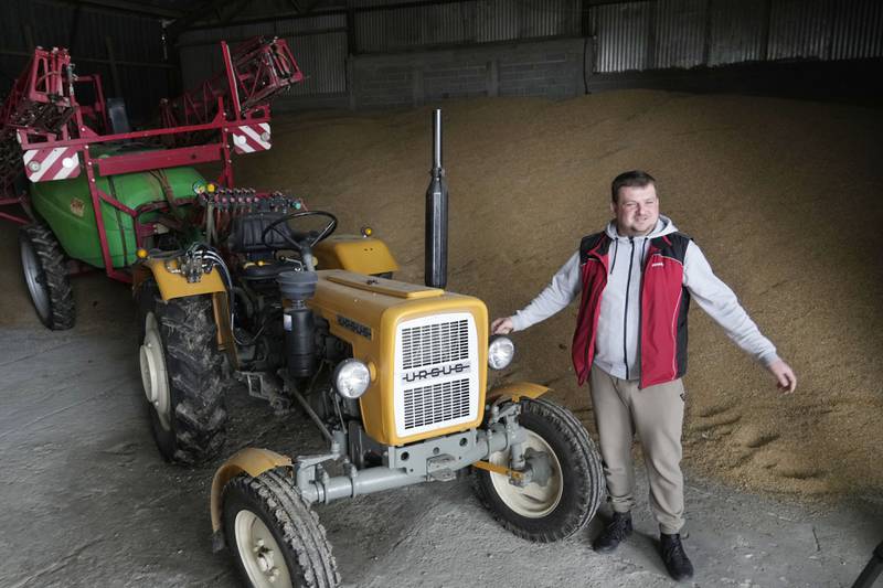 Piotr Korycki, a 34-year-old farmer, stands in a warehouse filled with grain on his farm in Poland. Korycki has been organizing protests of farmers that have been taking place for the past three months in Poland. They are among the Europe-wide protests by farmers angry about imports from Ukraine which they say are driving down prices.