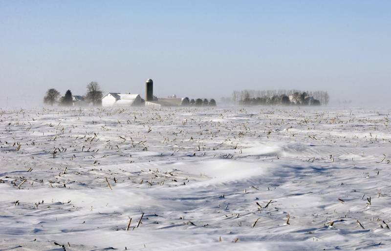 A farm is seen through blowing snow in DeKalb County in northern Illinois.