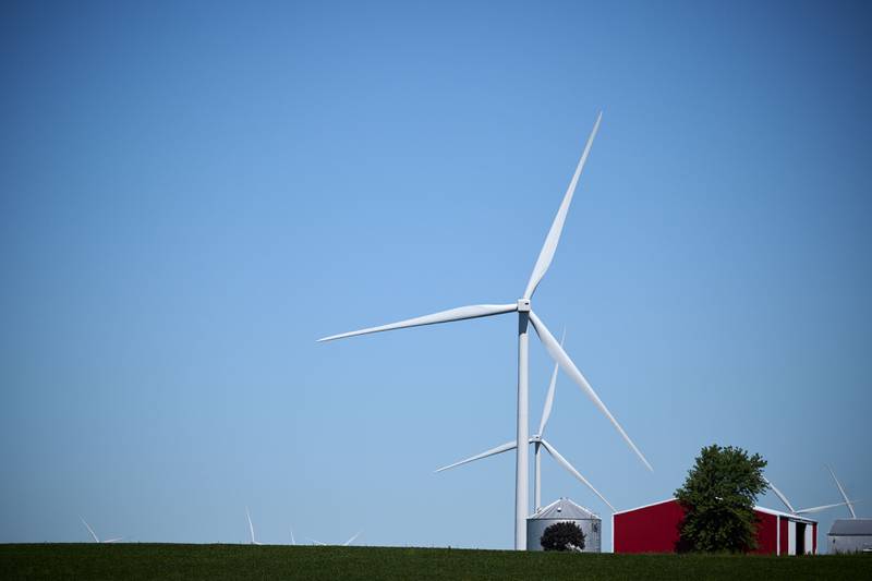 A general view of wind turbines on farmland with a large red barn in rural Gibson City in east-central Illinois.